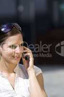 Business female on the phone outside
