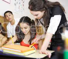 Boy Cheating while teacher helping