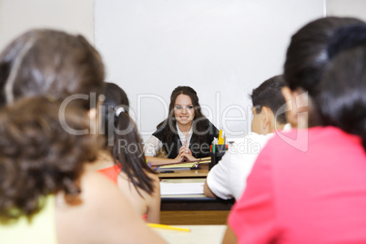 Teacher sitting in front of class