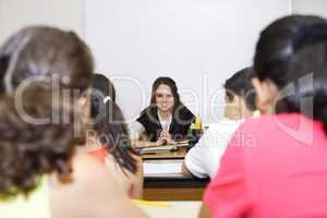 Teacher sitting in front of class