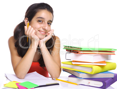 Teenage girl posing for the camera near her books