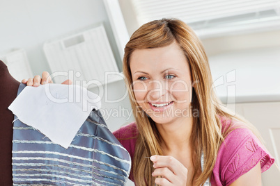 Positive young woman sewing clothes at home