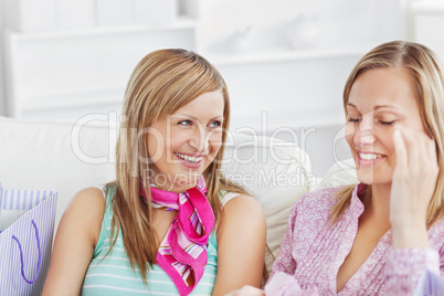 Two charming women talking together on the sofa