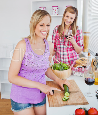 Cheerful women cooking together at home