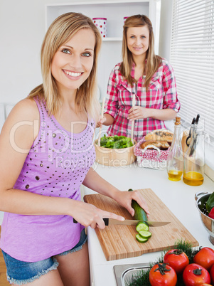 Cheerful women cooking together at home