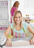 Beautiful caucasian woman baking together with her friend