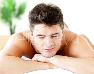 Portrait of an attractive man lying on a massage table