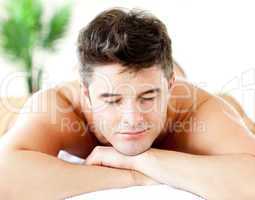 Portrait of an attractive man lying on a massage table