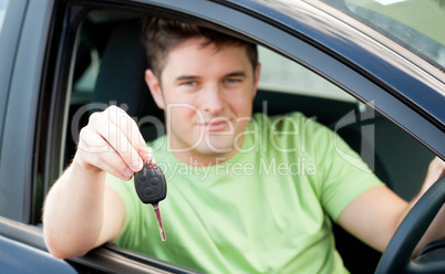 Happy caucasian man holding a car key