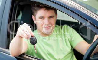 Happy caucasian man holding a car key