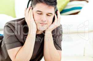 Relaxed man listen to music lying on the floor