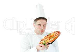Caucasian male cook holding a pizza