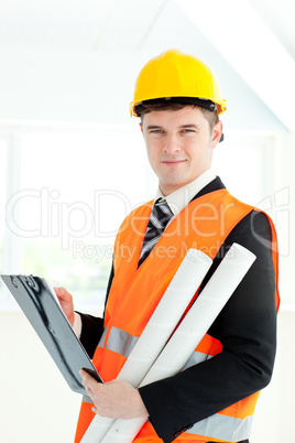 Self-assured archticet holding a clipboard and blueprints