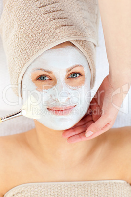 Smiling woman receiving a beauty treatment