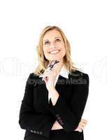 Confident businesswoman holding glasses smiling at the camera