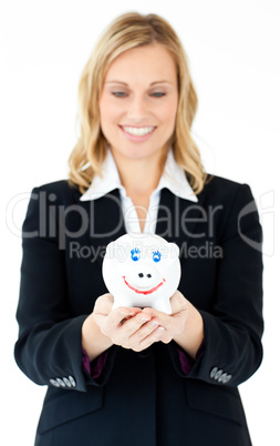 Charming businesswoman holding a piggy-bank