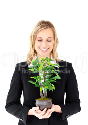 Portrait of a charismatic businesswoman holding a plant