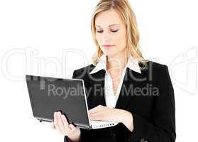 Self-assured businesswoman using her laptop standing