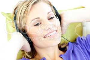 Joyful woman listening to music in the living-room