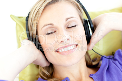 Delighted woman listening to music in the living-room