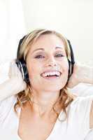 Bright young woman listening to music wearing headphones