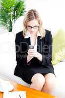 Angry businesswoman using her cellphone in the office