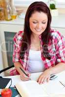 Cute student doing her homework at home