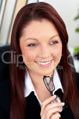 Cute businesswoman holding glasses