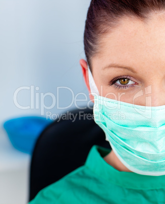 Close-up of a beautiful female doctor with scrubs sitting in her