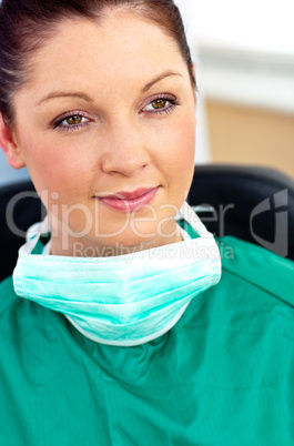 Beautiful female doctor with scrubs sitting in her office