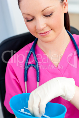 Self-assured female surgeon with a stethoscope holding pillls