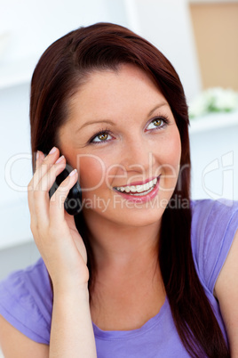 Merry woman using her cellphone at home
