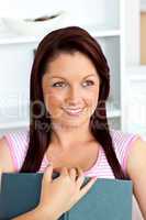 Serious woman reading a book at home