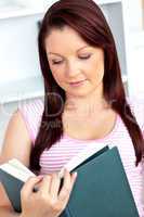 Concentrated woman reading a book at home