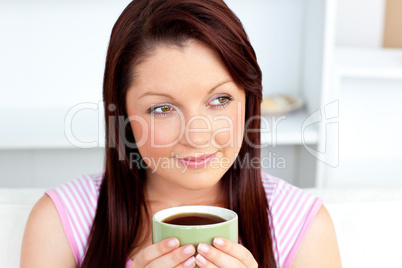 Caucasian woman holding a cup of coffee at home