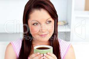 Caucasian woman holding a cup of coffee at home