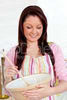 Confident woman cooking a cake at home