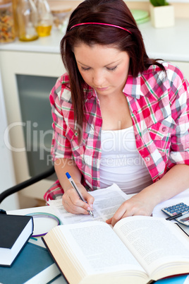 Concentrated student doing her homework at home