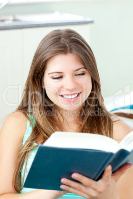 Bright caucasian woman reading a book at home