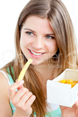 Pretty caucasian woman eating frensh frice at home