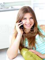 Positive woman talking on phone at home