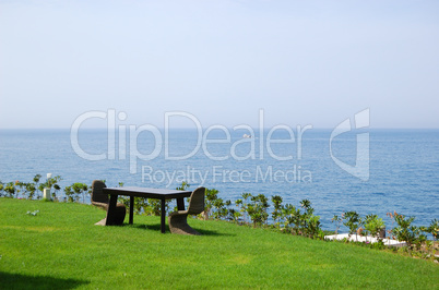 Lawn chairs and table at luxury villa, Crete, Greece