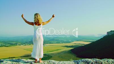 A girl stands on a rock