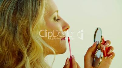 Blonde uses lipstick