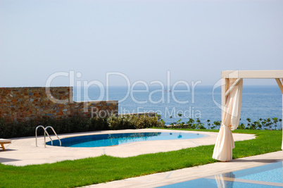 Swimming pool with jacuzzi at the beach of modern luxury villa,