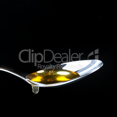 Honiglöffel/ spoon with honey (isolated on black)