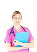 Thoughtful female surgeon holding a clipboard