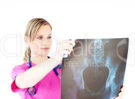 Serious female surgeon holding a x-ray