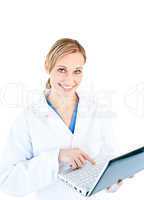 Charming female doctor holding a laptop looking at the camera