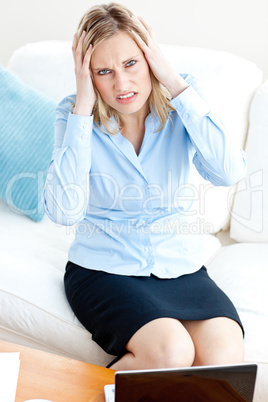 Tired businesswoman sitting on her sofa getting frustrated with